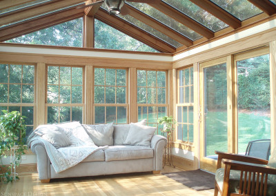 A sunroom framed and detailed with mahogany wood is located to the rear of this residence