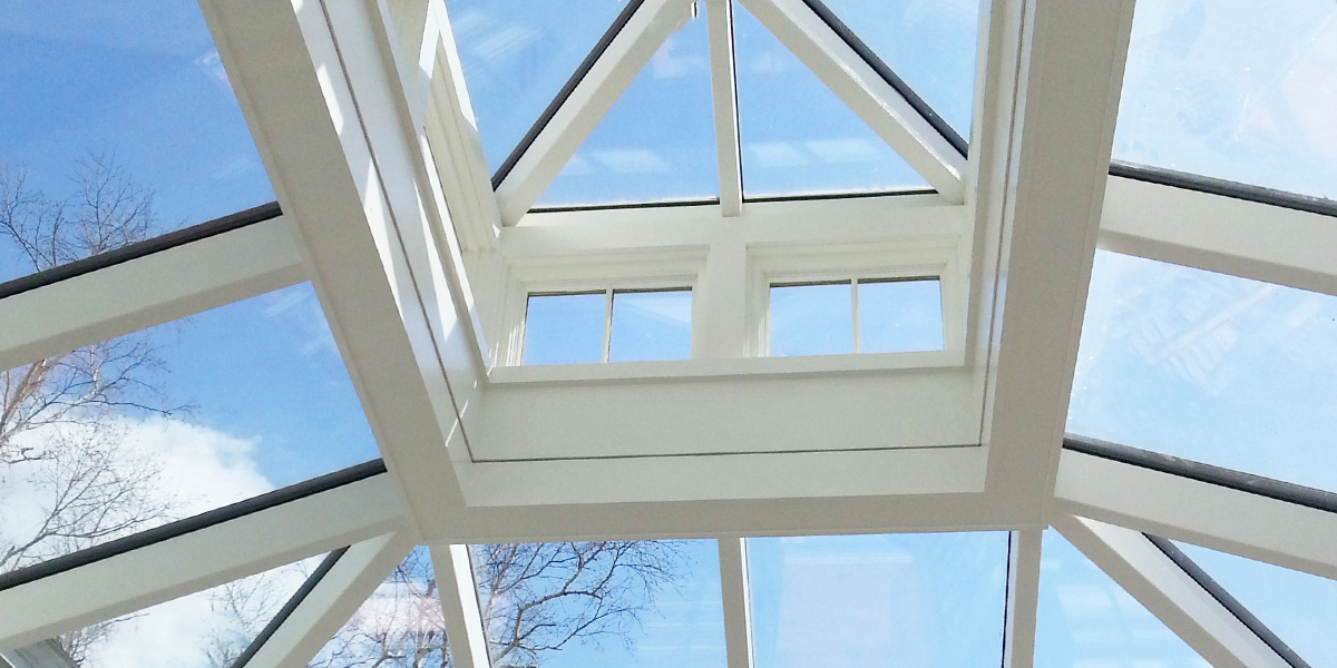 A view of a skylight and glass roof system featuring solid mahogany framing and high-performance insulated roof glass