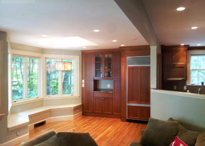 A view of this Belmont, Massachusetts kitchen's new custom cabinetry and recessed seating area adjacent to brand new windows