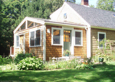 An exterior view of a rustic Gloucester home that has received a brand new sunroom-style kitchen expansion