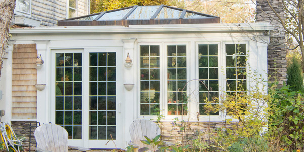 An outdoor photograph of a custom family room with a double-hip skylight located in Newbury, Massachusetts